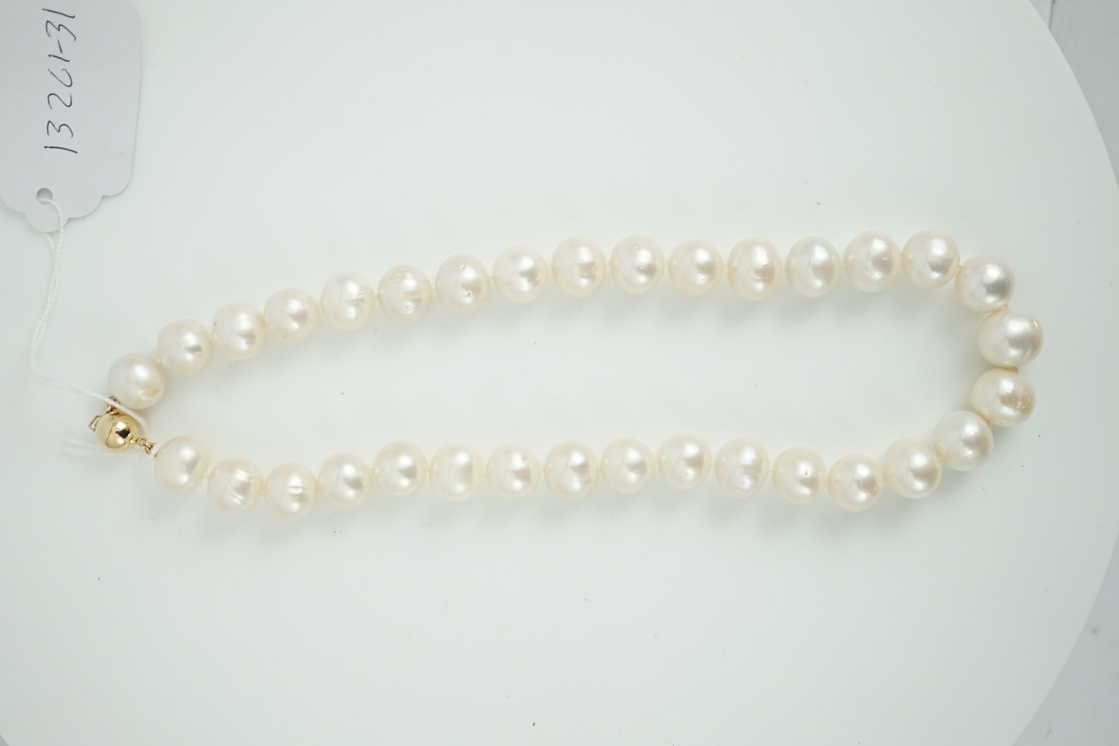 A single strand South Sea? cultured pearl necklace, with 14k yellow metal clasp, 44cm